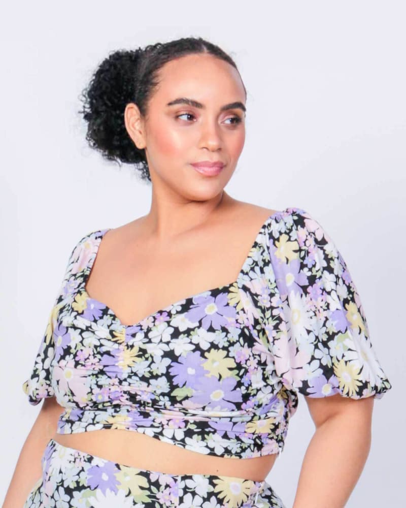 Front of a model wearing a size L (12/14) Sonny Puff Sleeve Crop Top in Daisy Print by LuvMeMore. | dia_product_style_image_id:266769